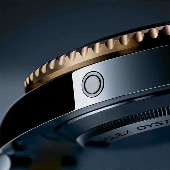 A close up of the helium escape valve on the Rolex Sea-Dweller in 18K yellow gold and Oystersteel. Model #126603.