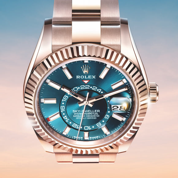 A downward photo of the Rolex Sky-Dweller in 18K Everose gold with a blue-green dial. Ref #M336935-0001.