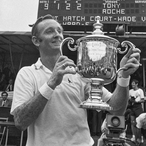 Rolex testimonee Rod Laver holding the US Open Championship trophy.