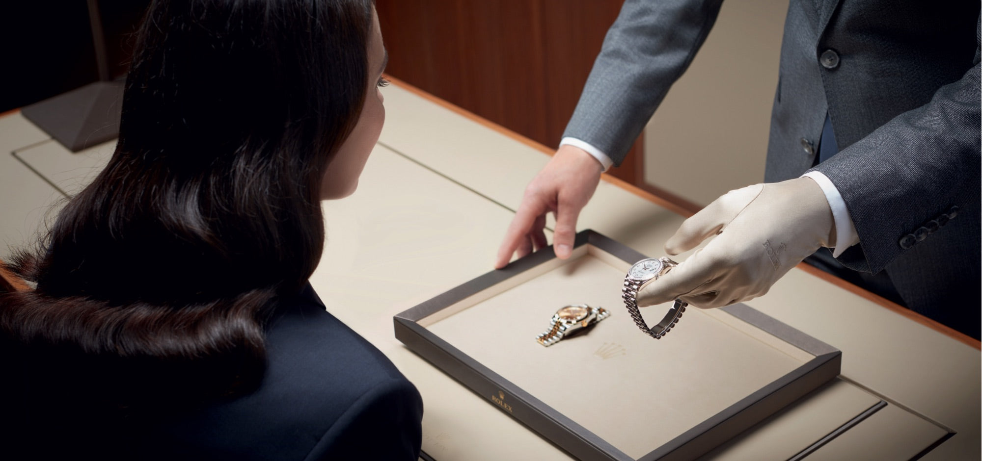 A Rolex advisor showing a client a Rolex watch.