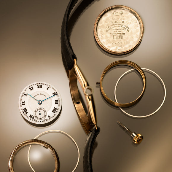 A vintage Rolex Oyster from 1926 disassembled into its component parts.