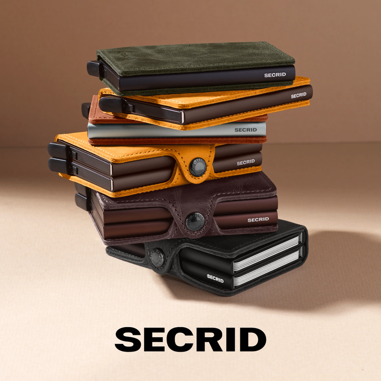 A Secrid wallet with the cards out in brown leather.