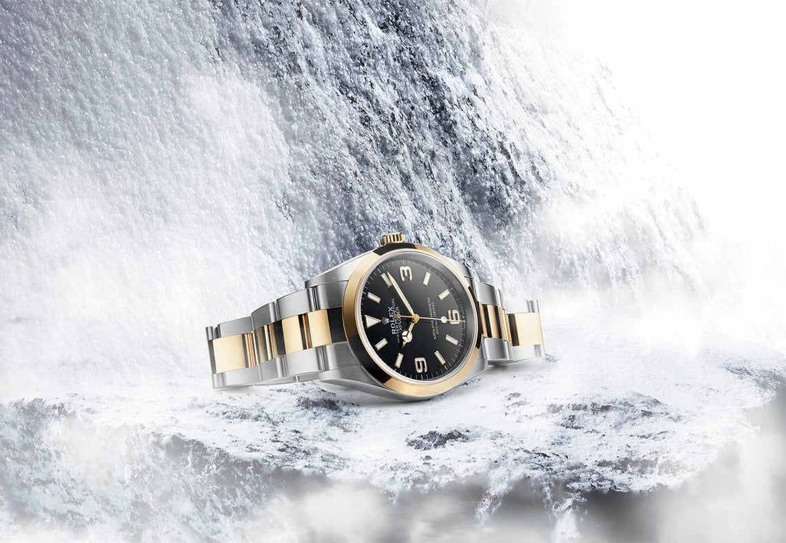 The new Rolex Explorer in 18K yellow gold an Oystersteel resting on ice with an icy back wall. Model #124273.
