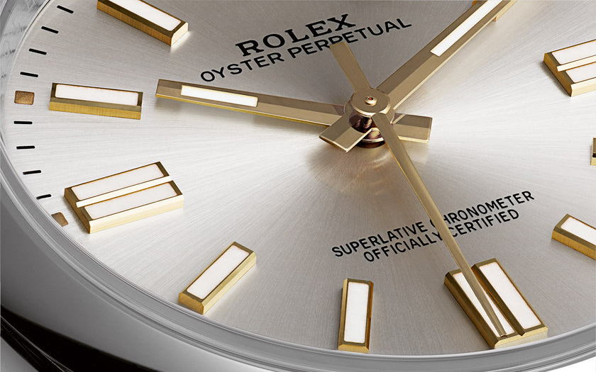 A close up shot of the bottom left quadrant of the Rolex Oyster Perpetual 41 watch with the silver dial. Just above the 6 o'clock marker reads 