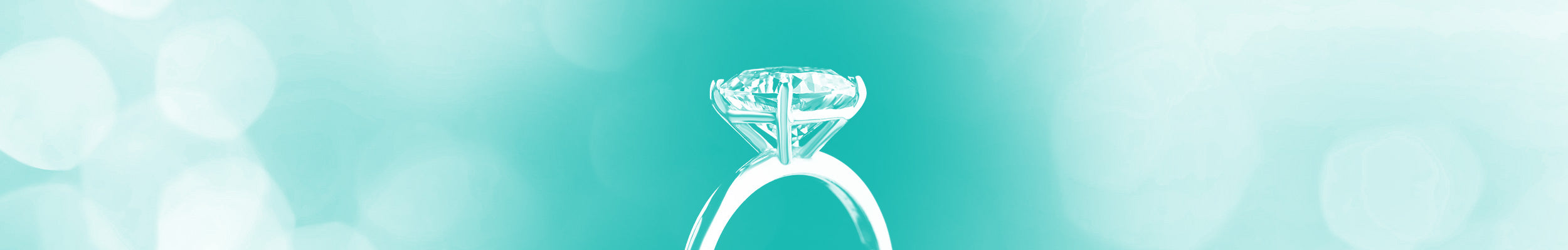 A solitaire diamond engagement ring on a teal background.