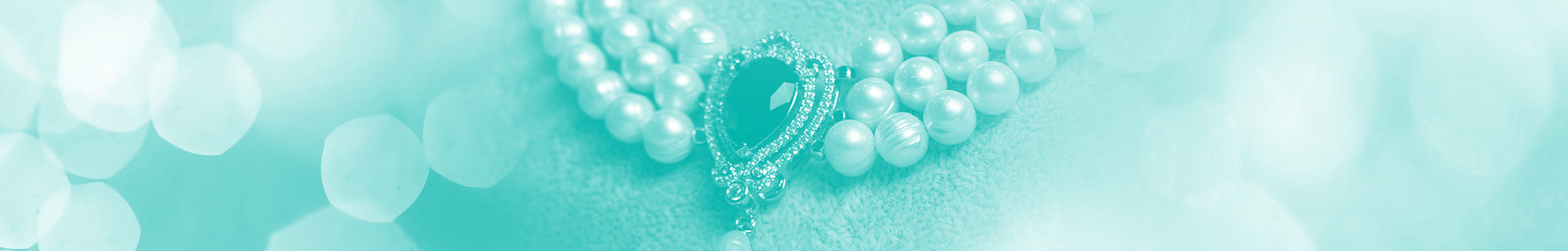 A vintage pearl and black gemstone 3 strand necklace with a teal background.