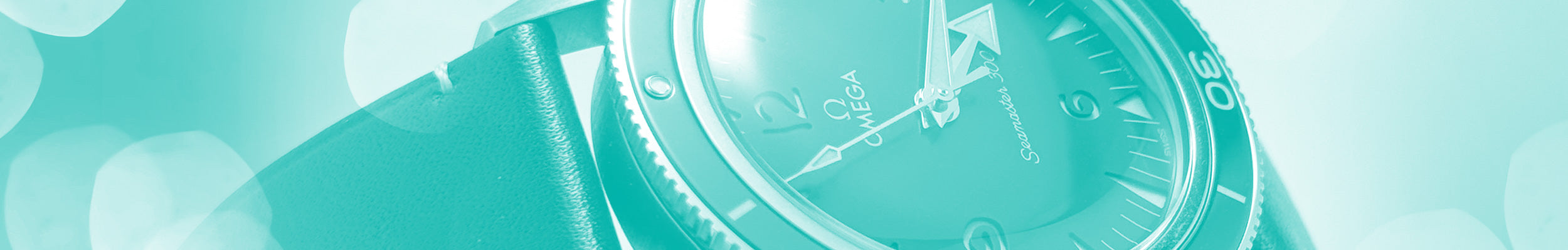 Close up image of a pre-owned OMGEA watch with a teal background.