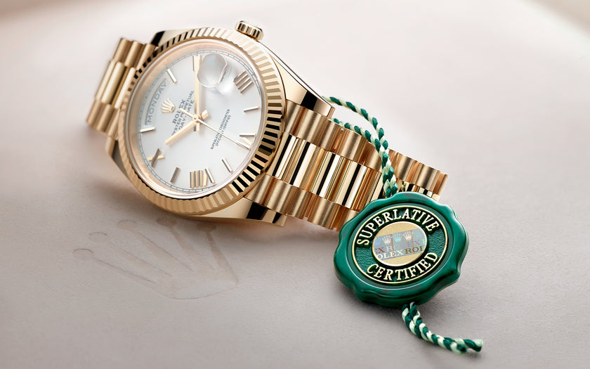 Rolex Day-Date 40 in 18K yellow gold with a white Roman numeral dial. Model #228238. Shown with the Rolex green Superlative Certified hang tag.